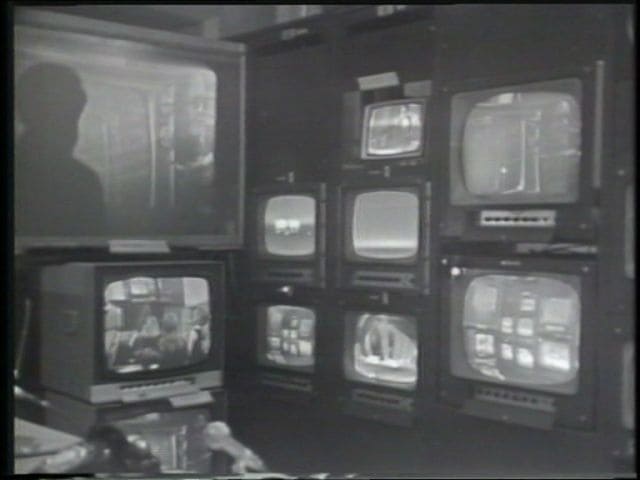 Black and white photo of vintage televisions displaying various images
