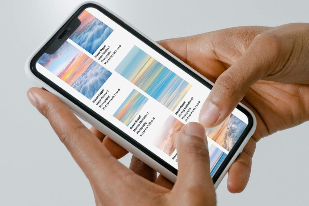 Person browsing an ArtPlacer Presentantion on a cell phone. ArtPlacer's Presentantions incorporate interactive wall art visualizers, that enable you to see the piece of art in a photo of your space or with AR directly on your wall.