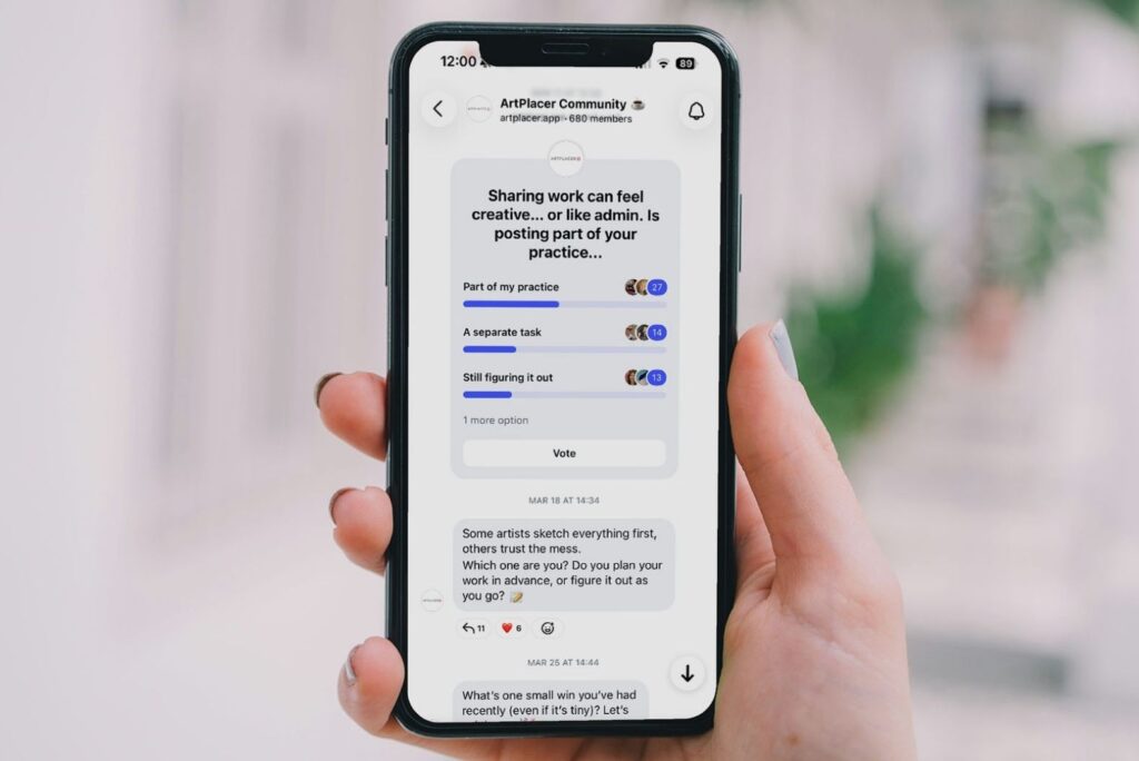 A hand holds a cell phone. The cell phone displays a poll with a lot of engagement in ArtPlacer’s Instagram Community Channel.